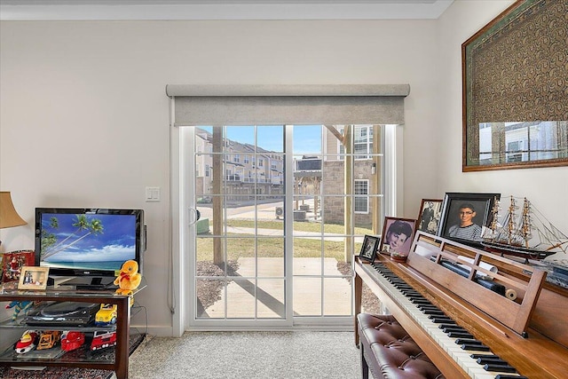doorway to outside with carpet floors and baseboards