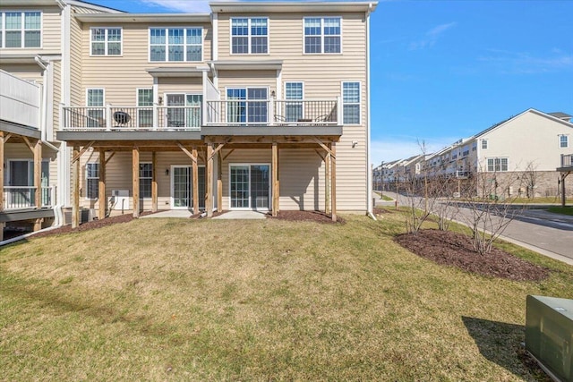 back of house with a yard and a residential view