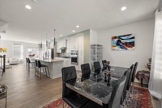 dining area with recessed lighting and wood finished floors