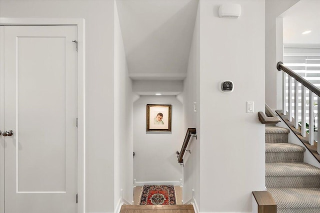 staircase featuring baseboards and recessed lighting