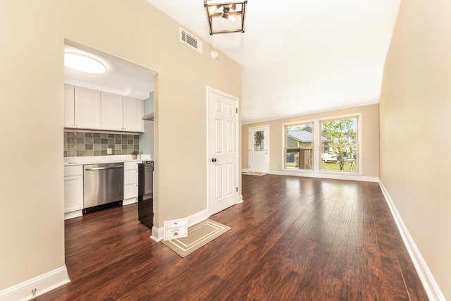 unfurnished living room with baseboards, visible vents, and dark wood-type flooring