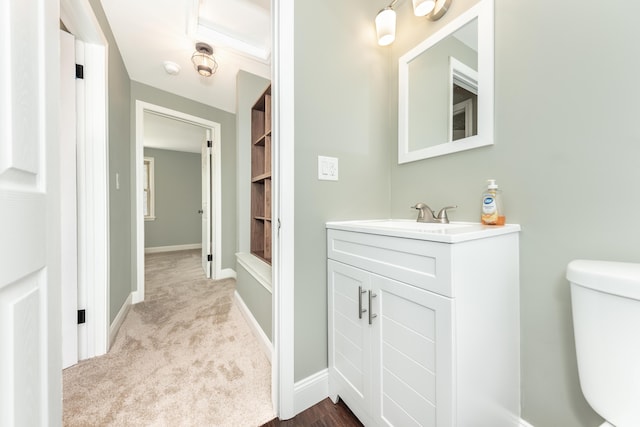 bathroom with vanity, baseboards, and toilet