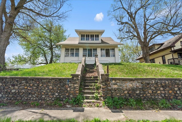 bungalow-style house with a front yard