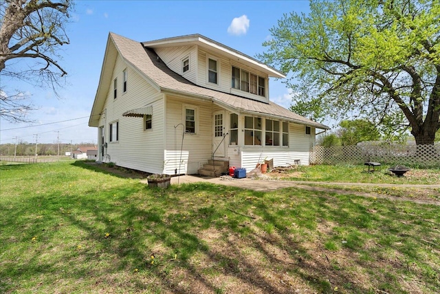 back of house featuring a yard and entry steps