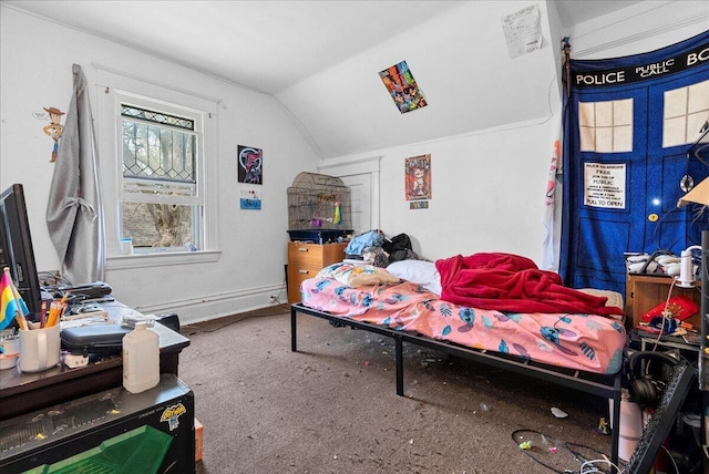 bedroom featuring baseboards, carpet, and vaulted ceiling