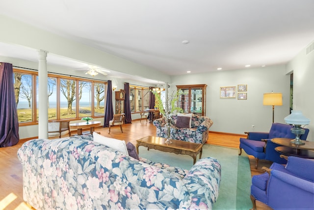 living room with a ceiling fan, visible vents, wood finished floors, ornate columns, and recessed lighting