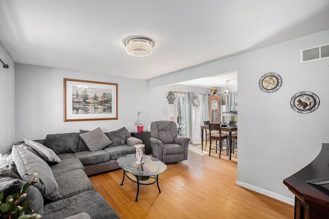 5184 Denwood St, Waterford, MI 48327 - living room featuring baseboards, light wood finished floors, and visible vents
