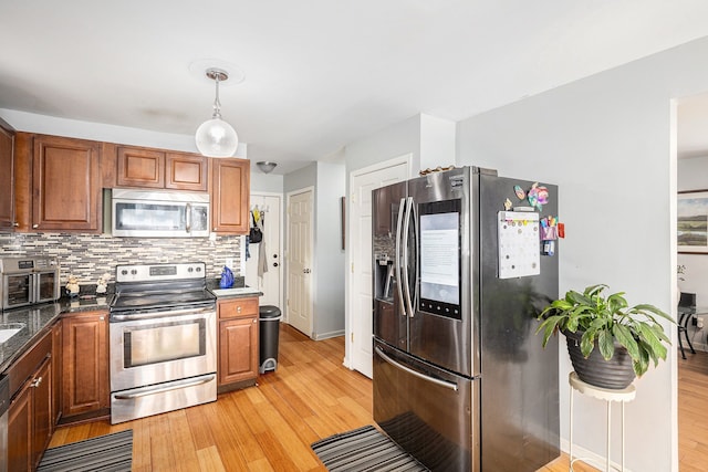 5184 Denwood St, Waterford, MI 48327 - kitchen with light wood-type flooring, brown cabinetry, backsplash, and stainless steel appliances