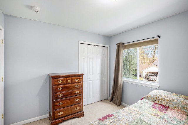 5184 Denwood St, Waterford, MI 48327 - bedroom featuring baseboards, light carpet, and a closet
