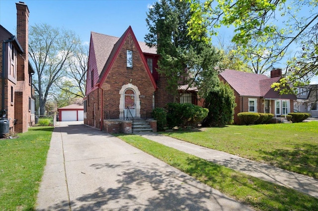 13936 Longacre St, Detroit, MI 48227 - english style home featuring brick siding, an outdoor structure, a front yard, and a detached garage