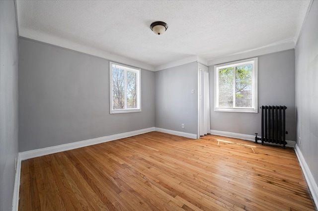13936 Longacre St, Detroit, MI 48227 - empty room featuring crown molding, radiator, light wood-type flooring, and a textured ceiling
