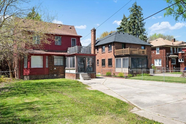 13936 Longacre St, Detroit, MI 48227 - rear view of property with a lawn, central AC, fence, and a balcony