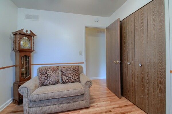 sitting room with visible vents and light wood-style flooring