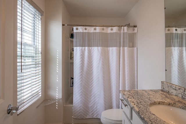 bathroom featuring vanity, shower / bathtub combination with curtain, and toilet