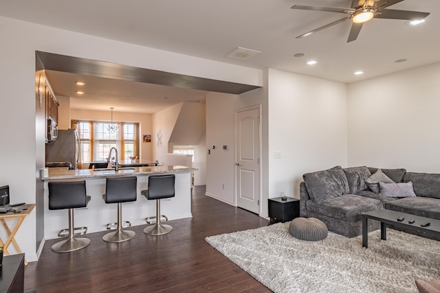 living area featuring recessed lighting, baseboards, a ceiling fan, and dark wood finished floors