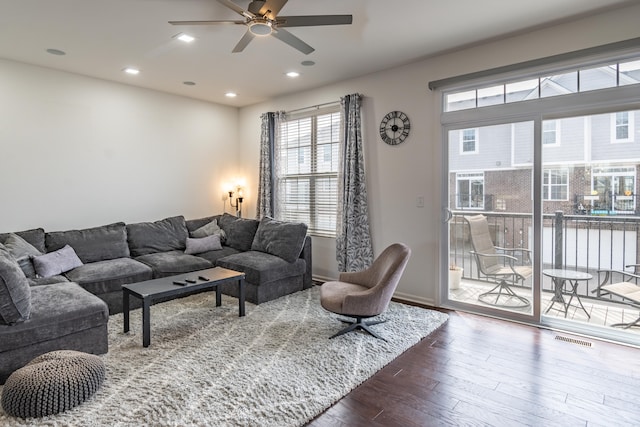 living room with ceiling fan, visible vents, baseboards, recessed lighting, and dark wood-type flooring