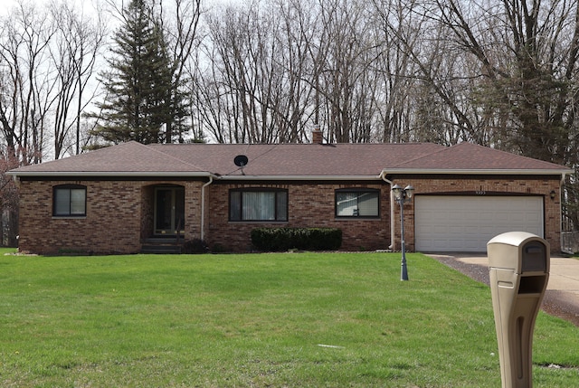 ranch-style house featuring brick siding, aphalt driveway, a front lawn, and a garage