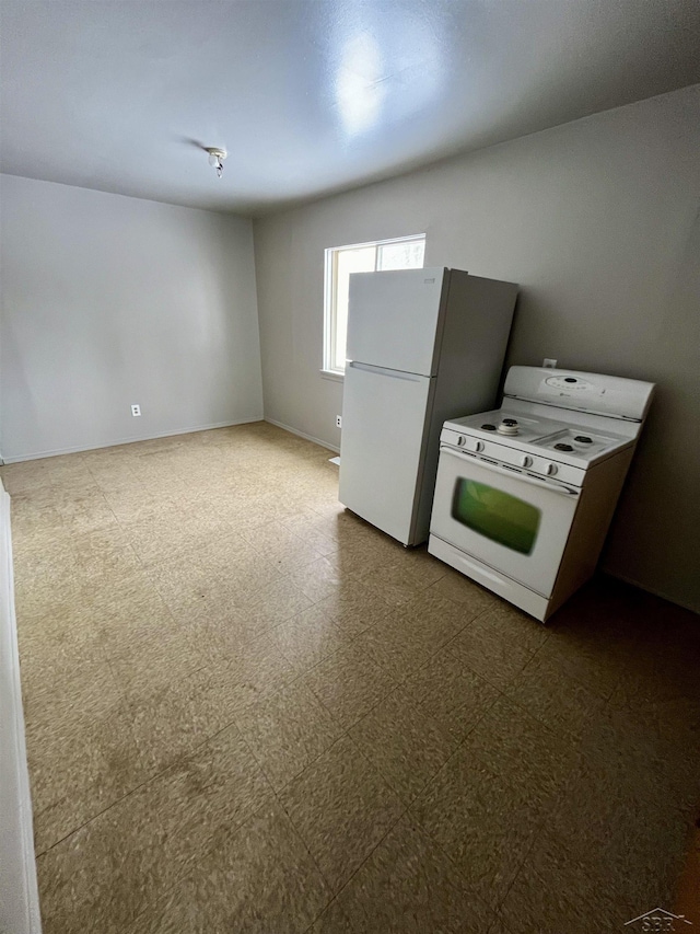 3704 Huntley St, Saginaw, MI 48601 - kitchen with dark floors and white appliances