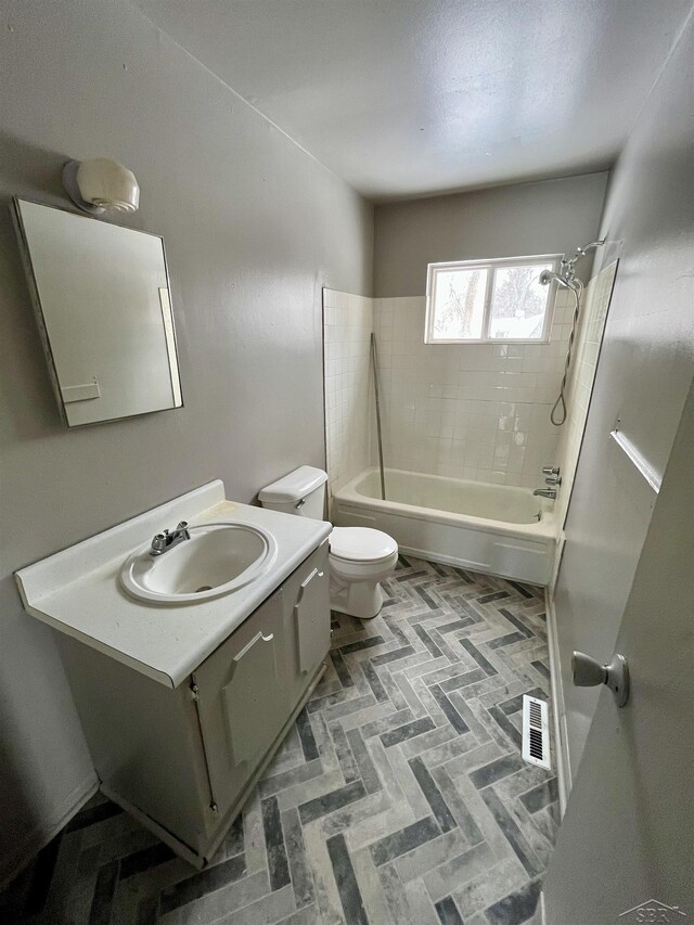 3704 Huntley St, Saginaw, MI 48601 - bathroom with brick floor, vanity, toilet, shower / bathing tub combination, and visible vents