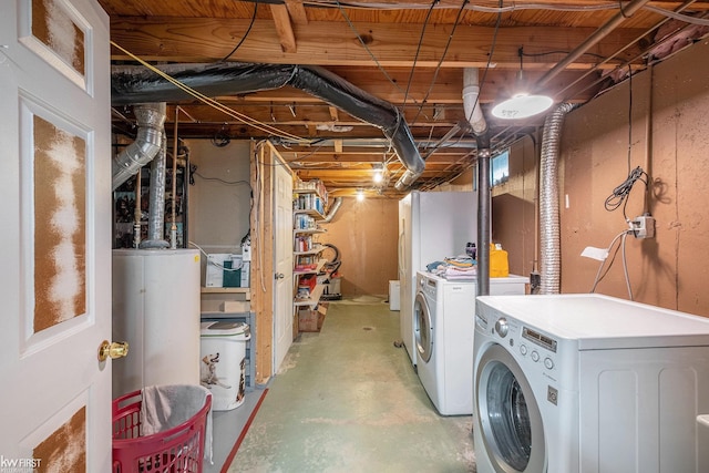unfinished below grade area featuring separate washer and dryer and gas water heater