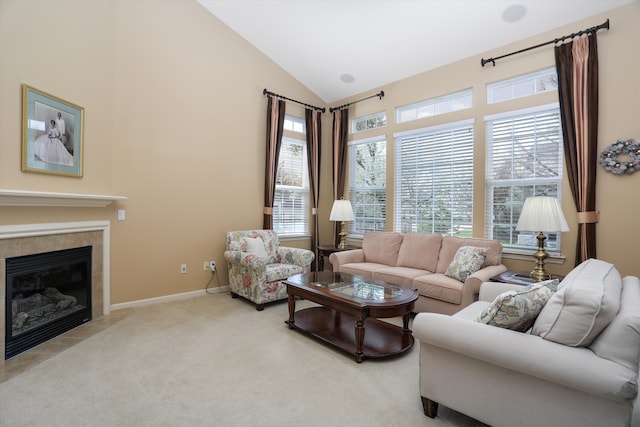 carpeted living area featuring baseboards, vaulted ceiling, and a tile fireplace