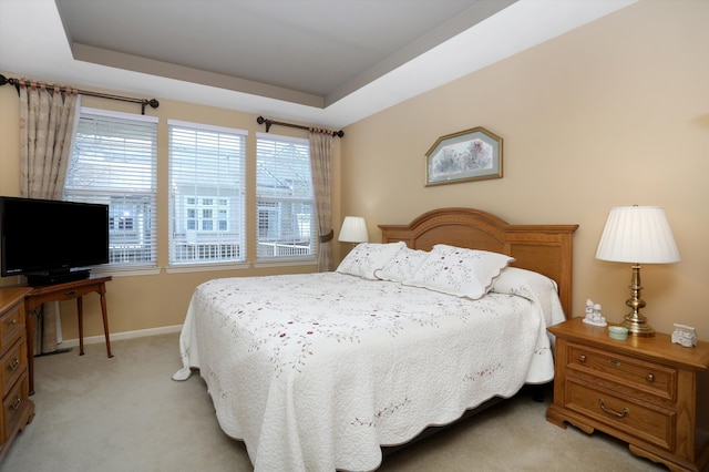 bedroom featuring baseboards and light colored carpet