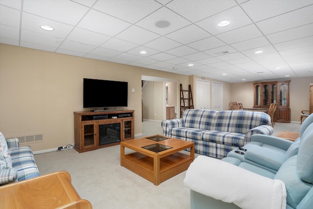 carpeted living area featuring recessed lighting, baseboards, and visible vents