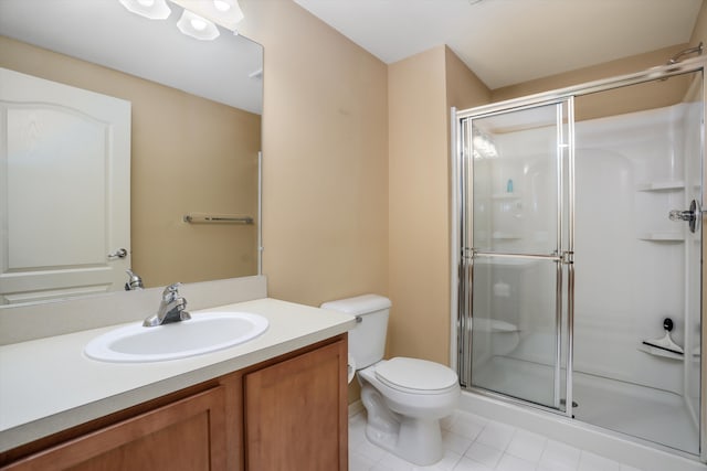 full bathroom featuring vanity, tile patterned flooring, a stall shower, and toilet
