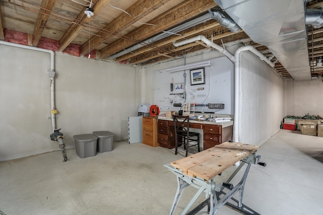 unfinished below grade area featuring a workshop area