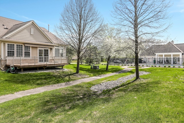exterior space with fence and a deck