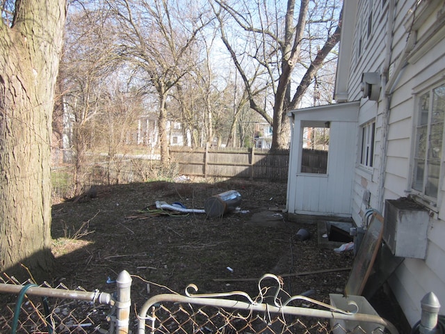 view of yard with fence and entry steps