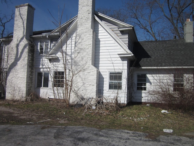 view of property exterior featuring a chimney
