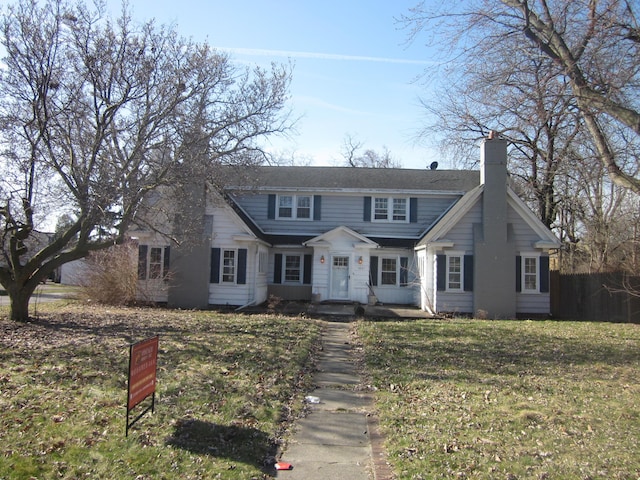 view of front of house with a front lawn and a chimney