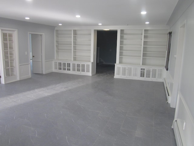 empty room with recessed lighting, built in features, and baseboard heating