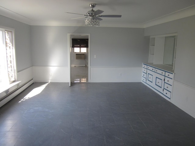 empty room with ornamental molding, a ceiling fan, and a baseboard heating unit