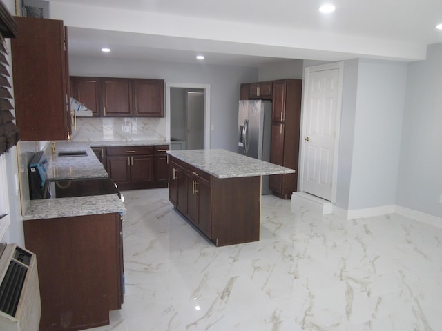 kitchen featuring a kitchen island, stainless steel refrigerator with ice dispenser, recessed lighting, and marble finish floor
