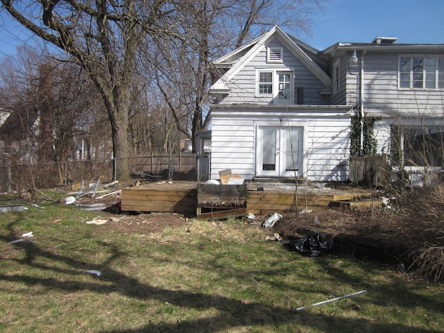 back of property featuring a yard, a deck, fence, and french doors