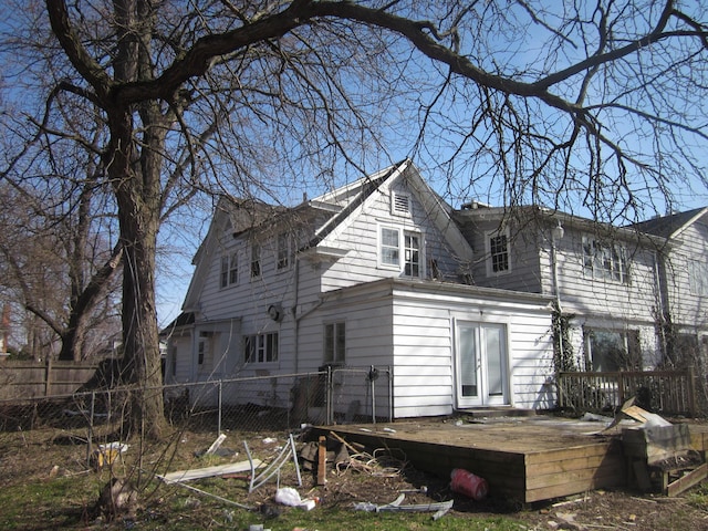 back of property featuring fence and a deck