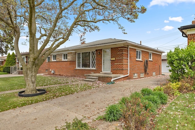 view of front of home with brick siding, a front yard, and a chimney