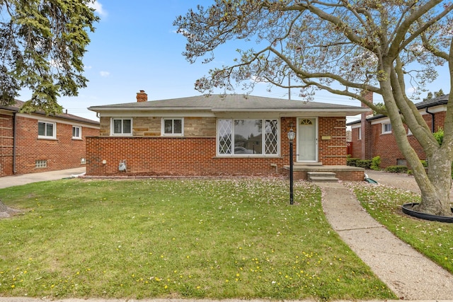 view of front of house with brick siding, a front yard, and a chimney
