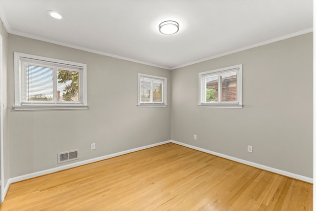 spare room with baseboards, visible vents, plenty of natural light, and light wood-style flooring