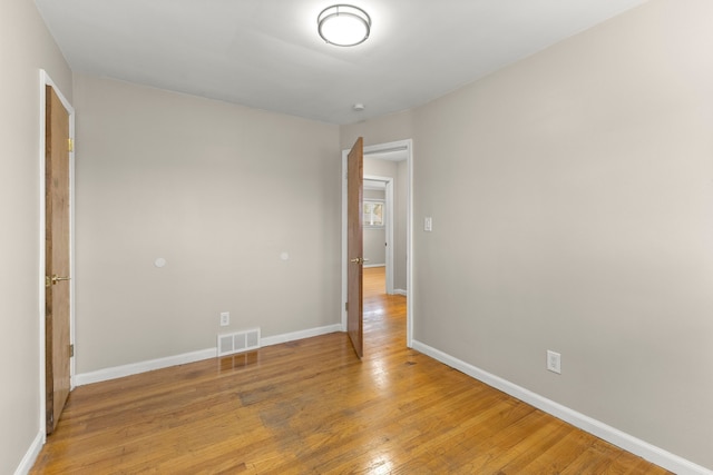 unfurnished bedroom featuring baseboards, visible vents, and light wood-style flooring