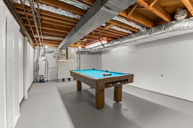 recreation room with concrete flooring, billiards, and water heater
