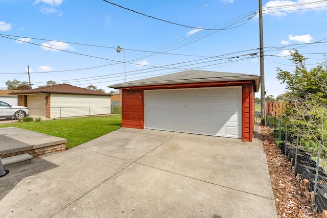 detached garage featuring fence