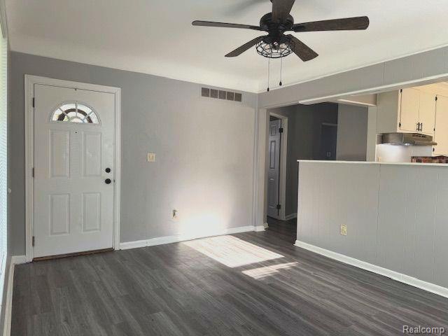 24101 Carlysle St, Dearborn, MI 48124 - unfurnished living room featuring dark wood-style flooring and a ceiling fan