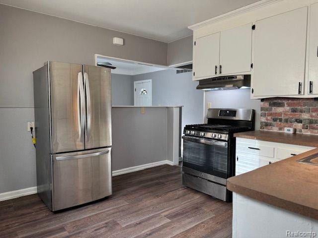 24101 Carlysle St, Dearborn, MI 48124 - kitchen with appliances with stainless steel finishes, under cabinet range hood, dark wood-style flooring, and white cabinets