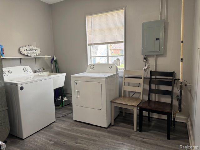 24101 Carlysle St, Dearborn, MI 48124 - laundry area with electric panel, washing machine and dryer, and wood finished floors