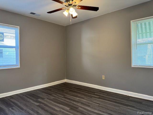 24101 Carlysle St, Dearborn, MI 48124 - empty room with dark wood-type flooring and a ceiling fan
