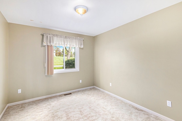 unfurnished room featuring visible vents, baseboards, and carpet floors