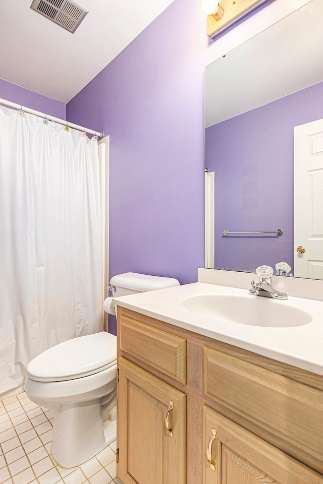 bathroom featuring visible vents, vanity, toilet, a shower with shower curtain, and tile patterned floors